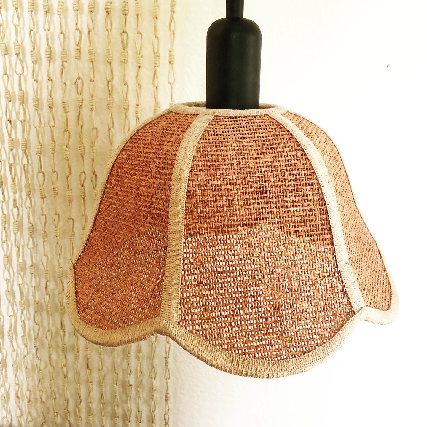 Suspension of woven fiber flowers