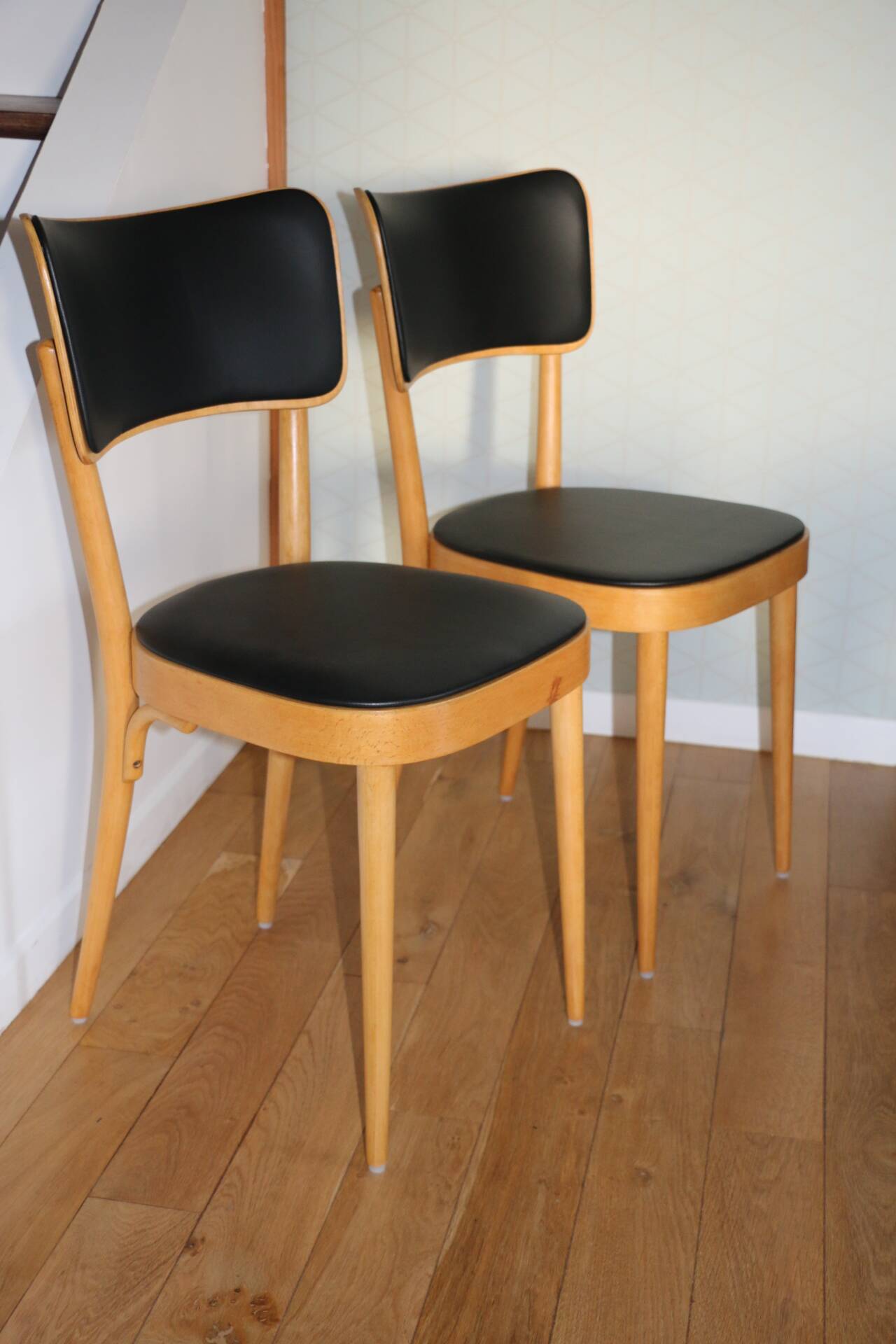 5 baumann chairs with large backs in black faux leather.