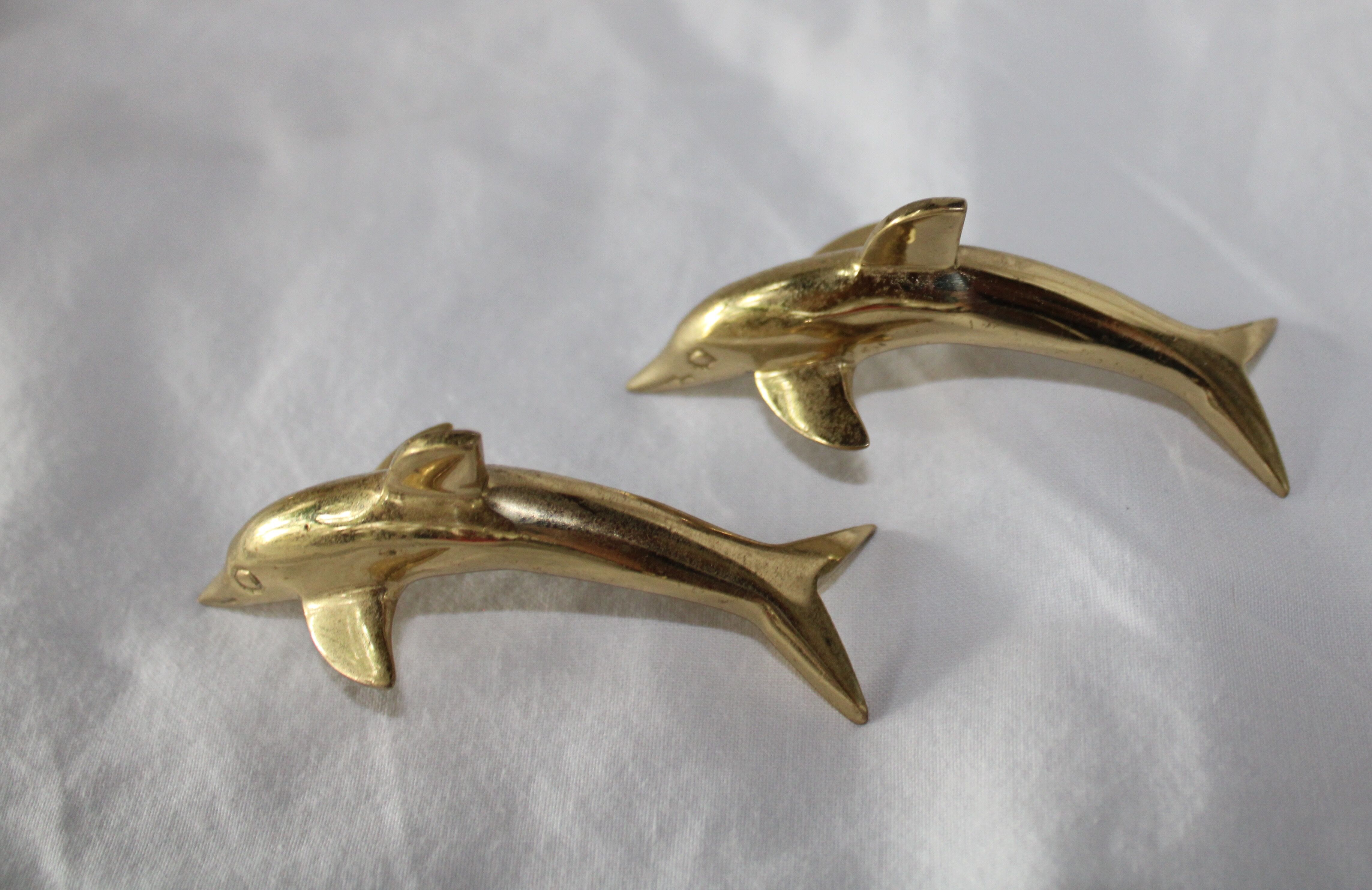 Family of dolphins in vintage brass