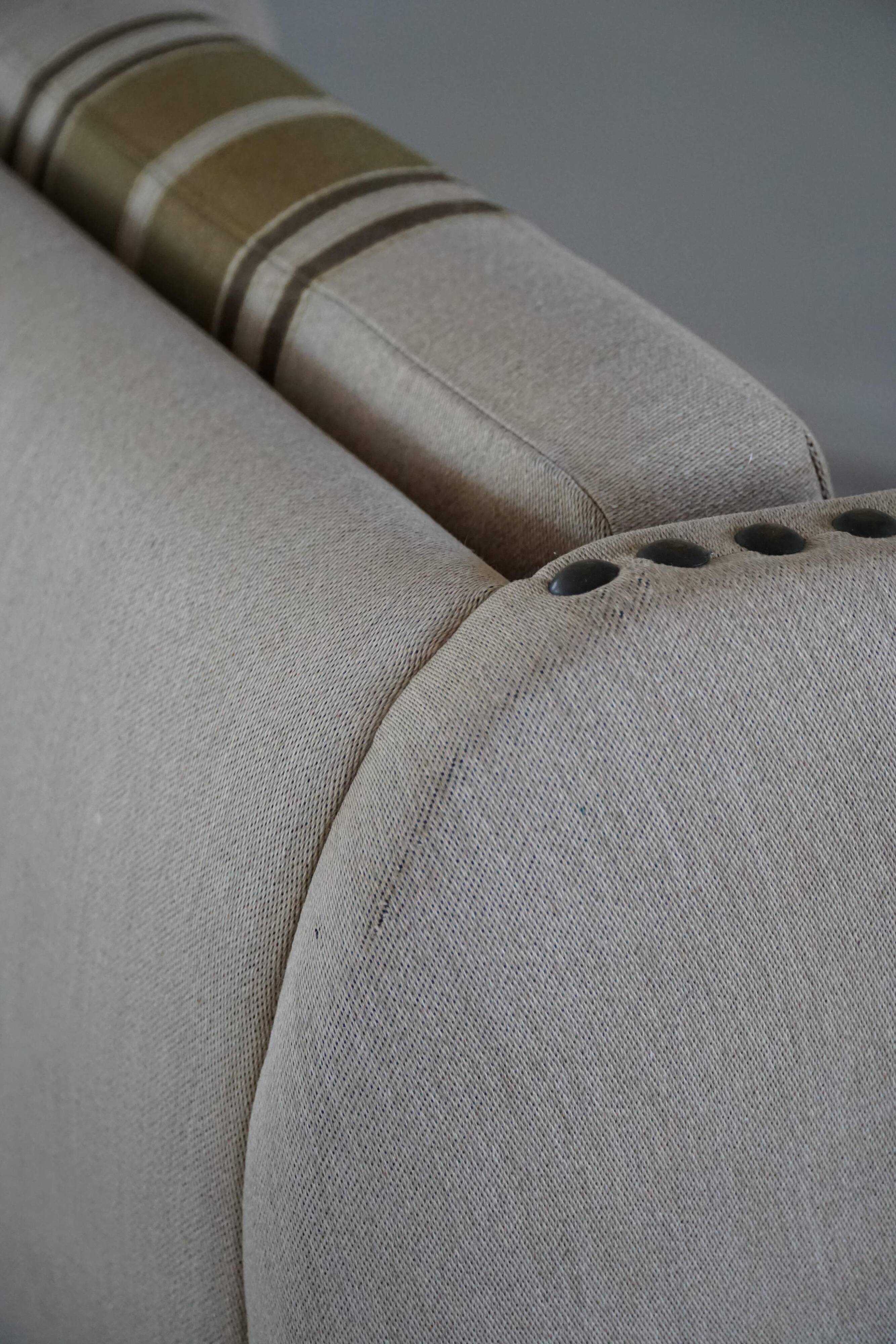 Pair of high-back lounge chairs in modern Danish style in the manner of Henning Kjærnulf, 1960s.