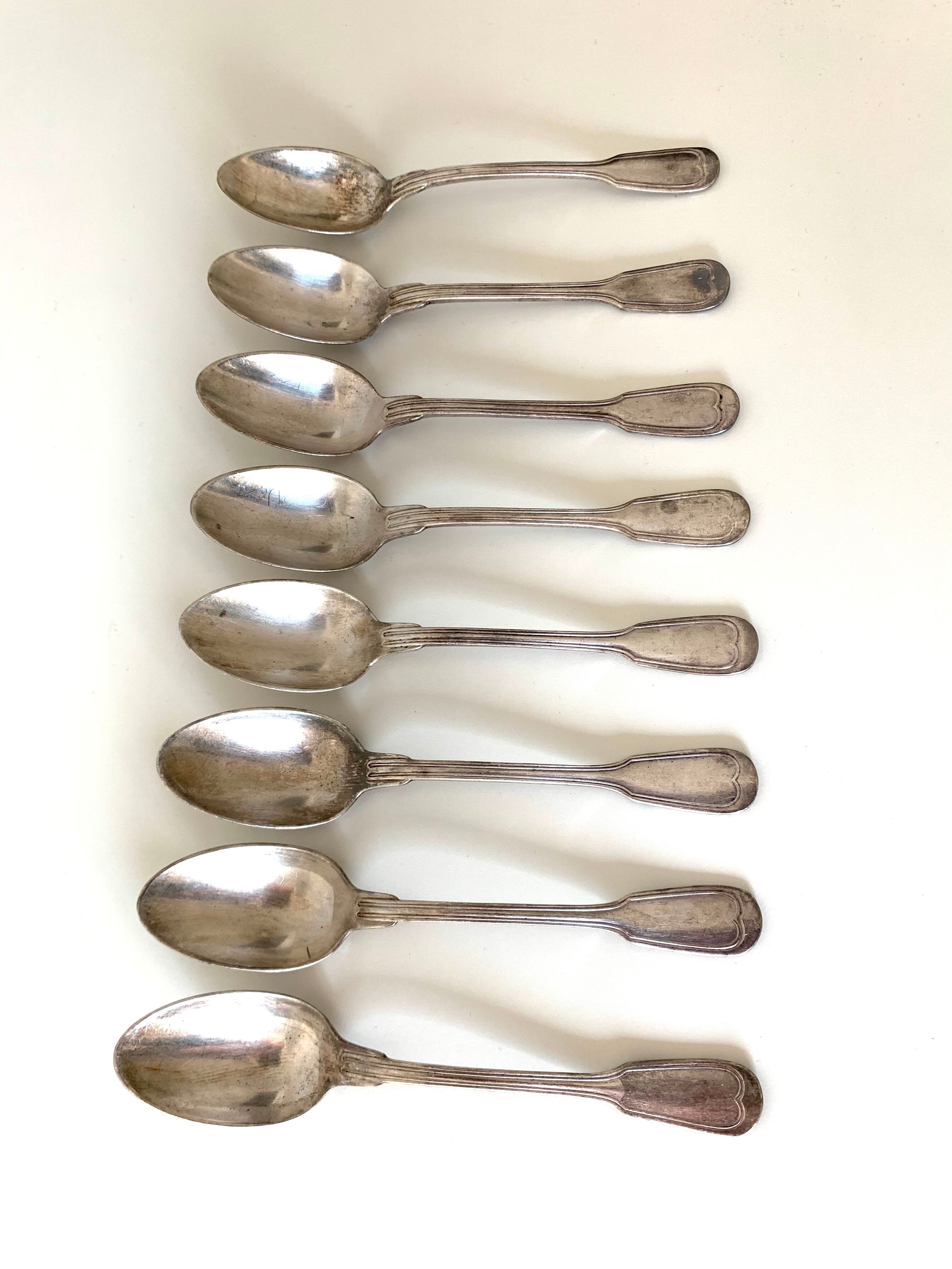 8 silver metal spoons