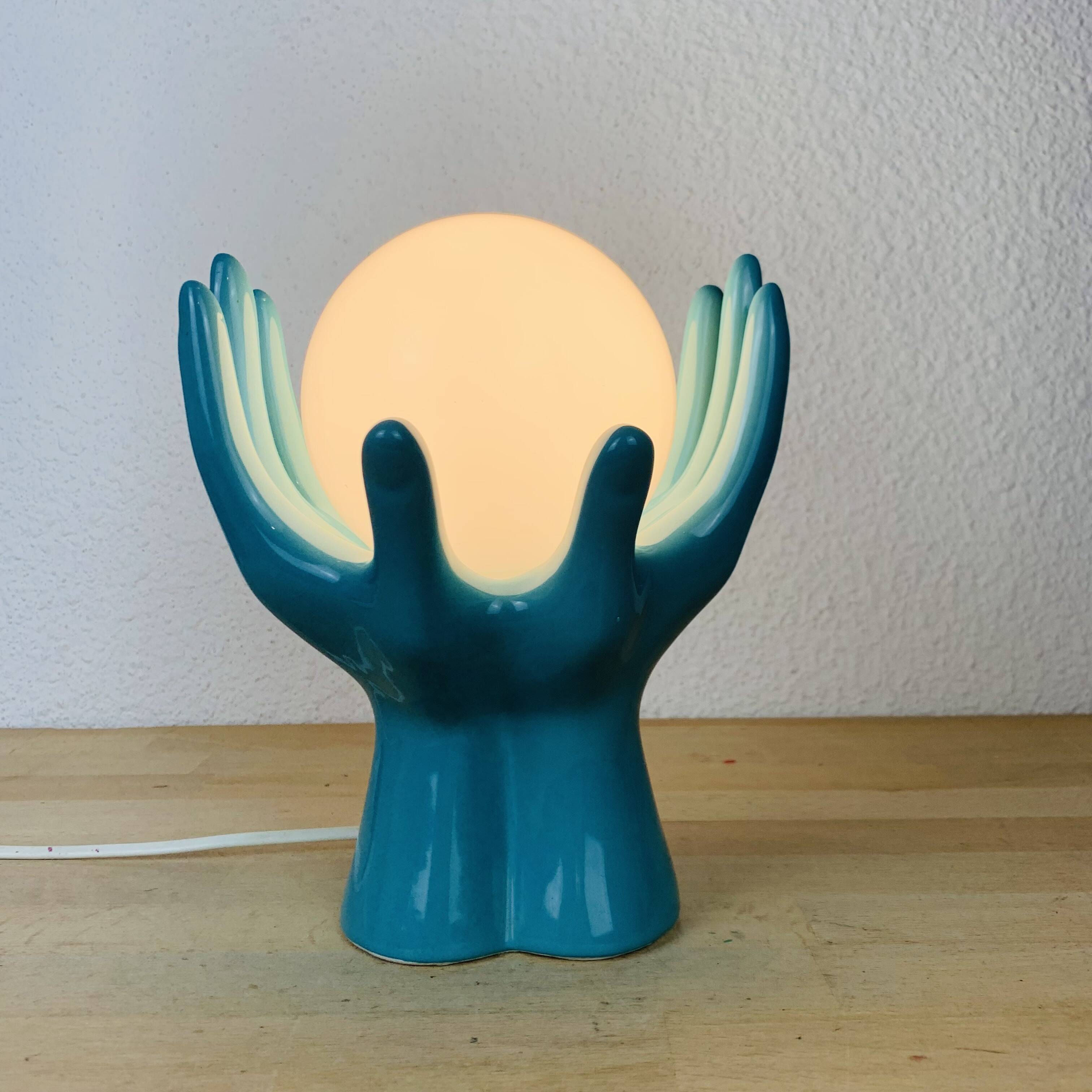 Blue ceramic hands lamp and glass globe