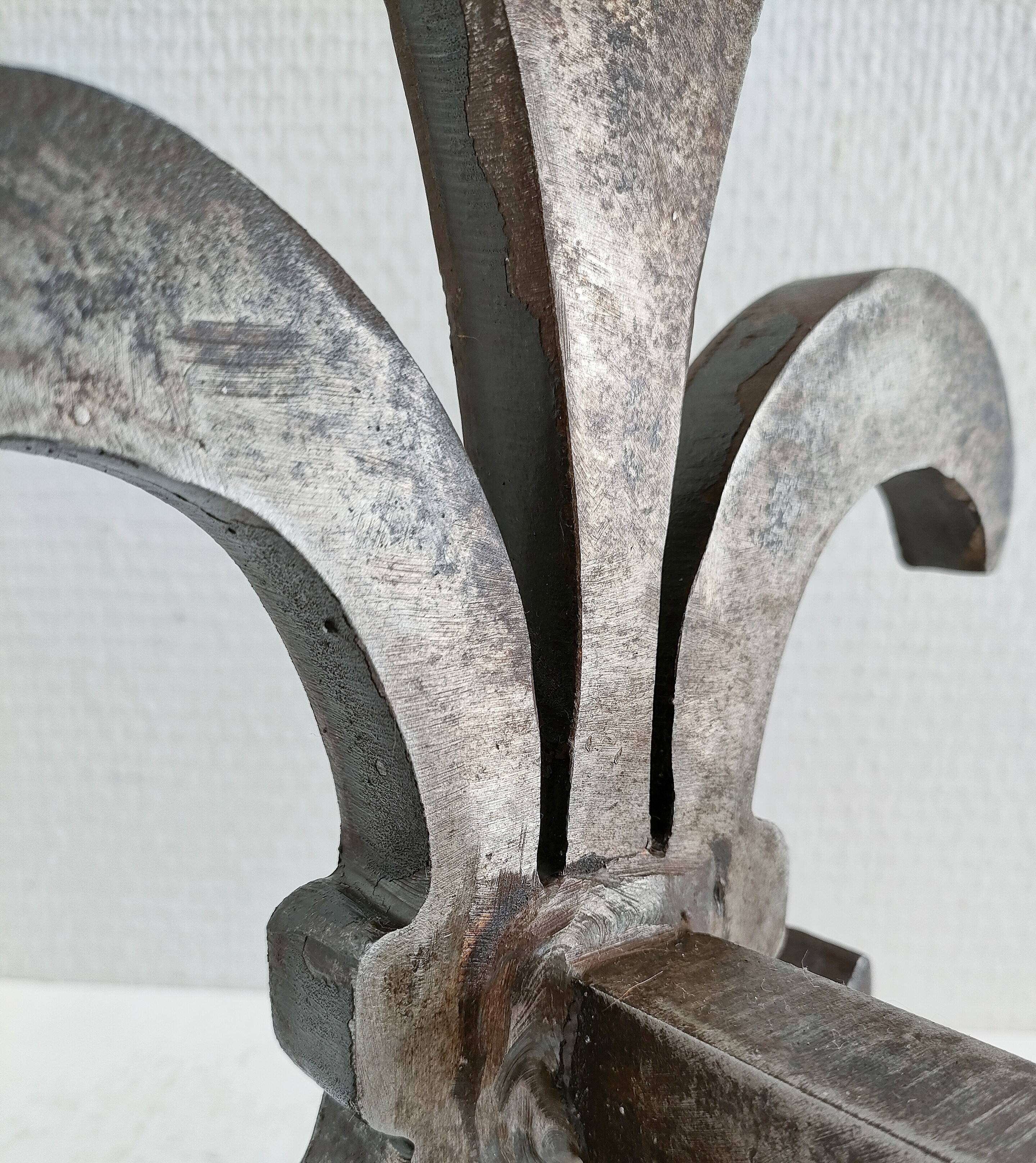 Pair of vintage steel fleur-de-lys andirons