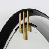Lacquered and patinated brass mirror, ovoid shape. 1950s/60s.