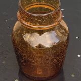 Blown and bubbled glass jar in the style of Biot glassworks, amber color
