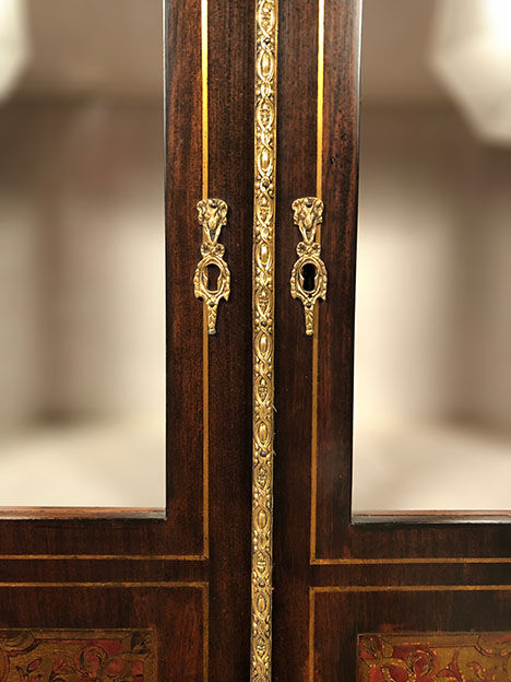 Varnished wood showcase and gold decoration in imitation of the so-called Boulle marquetry