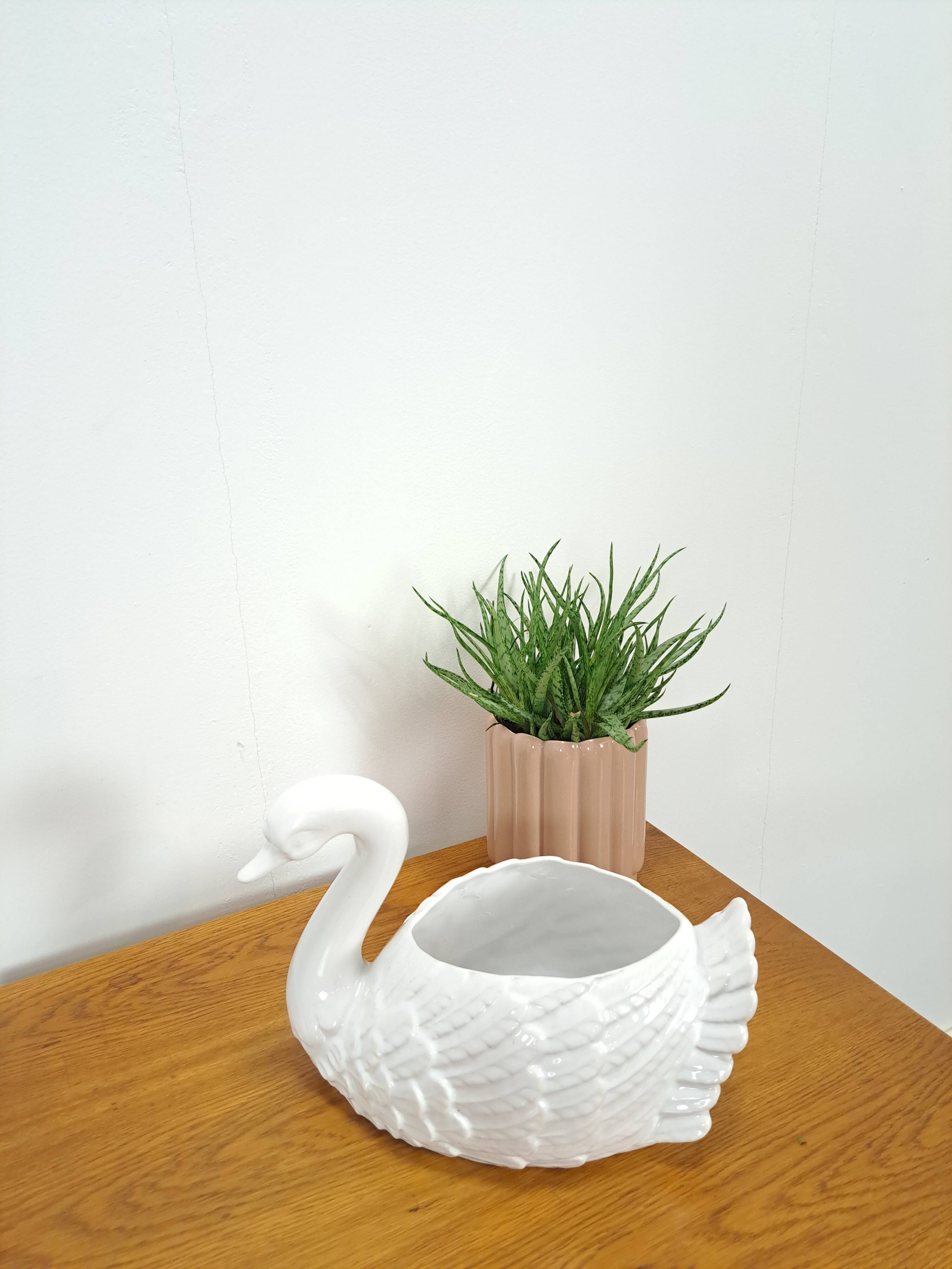 vintage porcelain flower pot in the shape of a swan