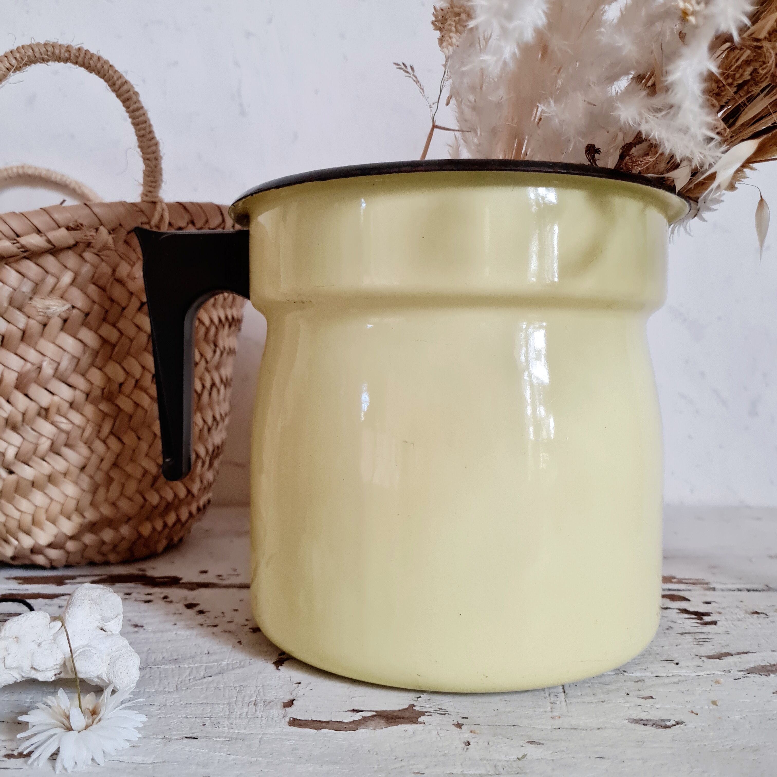 Old pitcher in yellow enamelled sheet metal