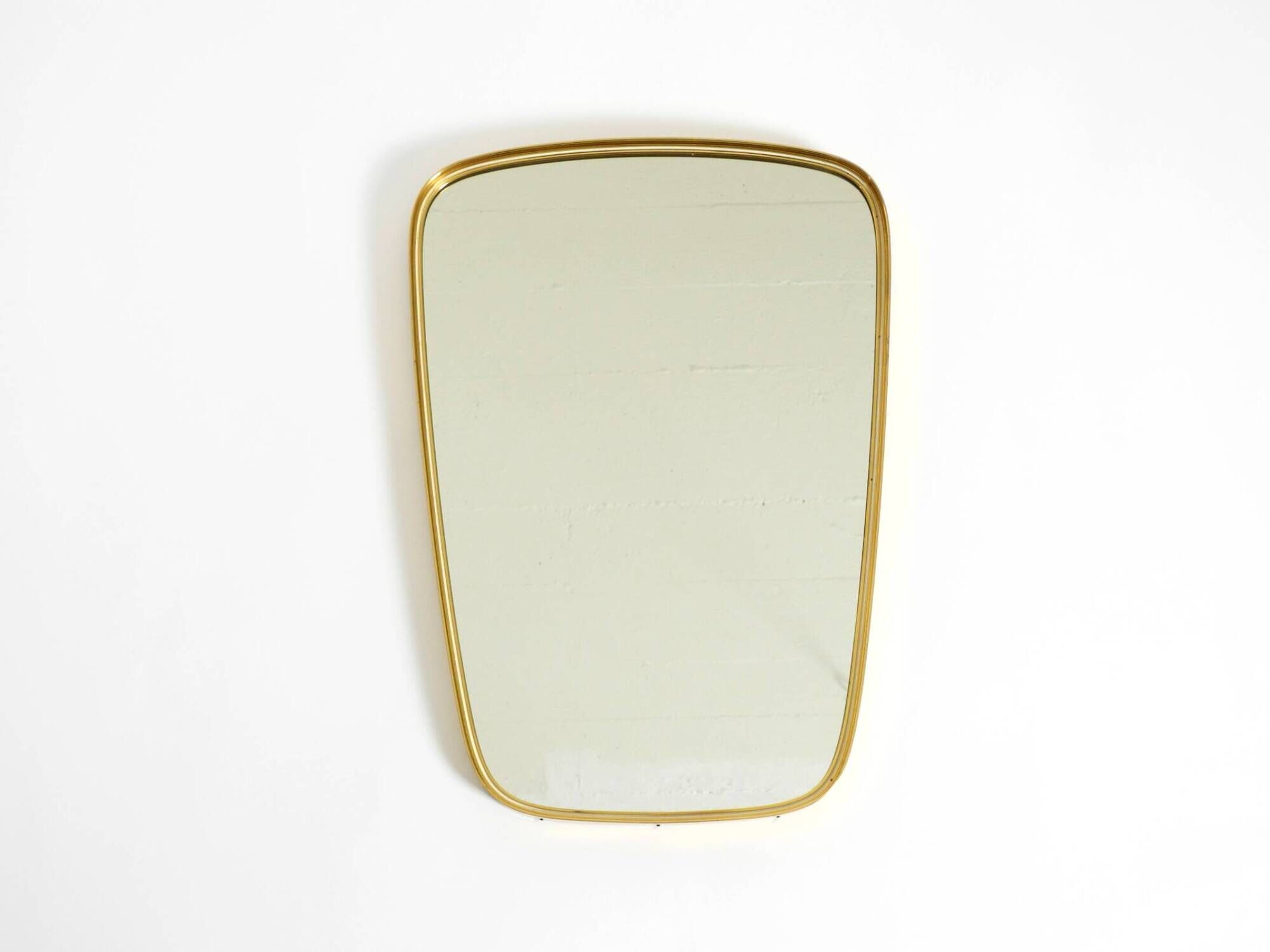 A pair of rare Mid Century "Münchener Zierspiegel" brass wall mirrors
