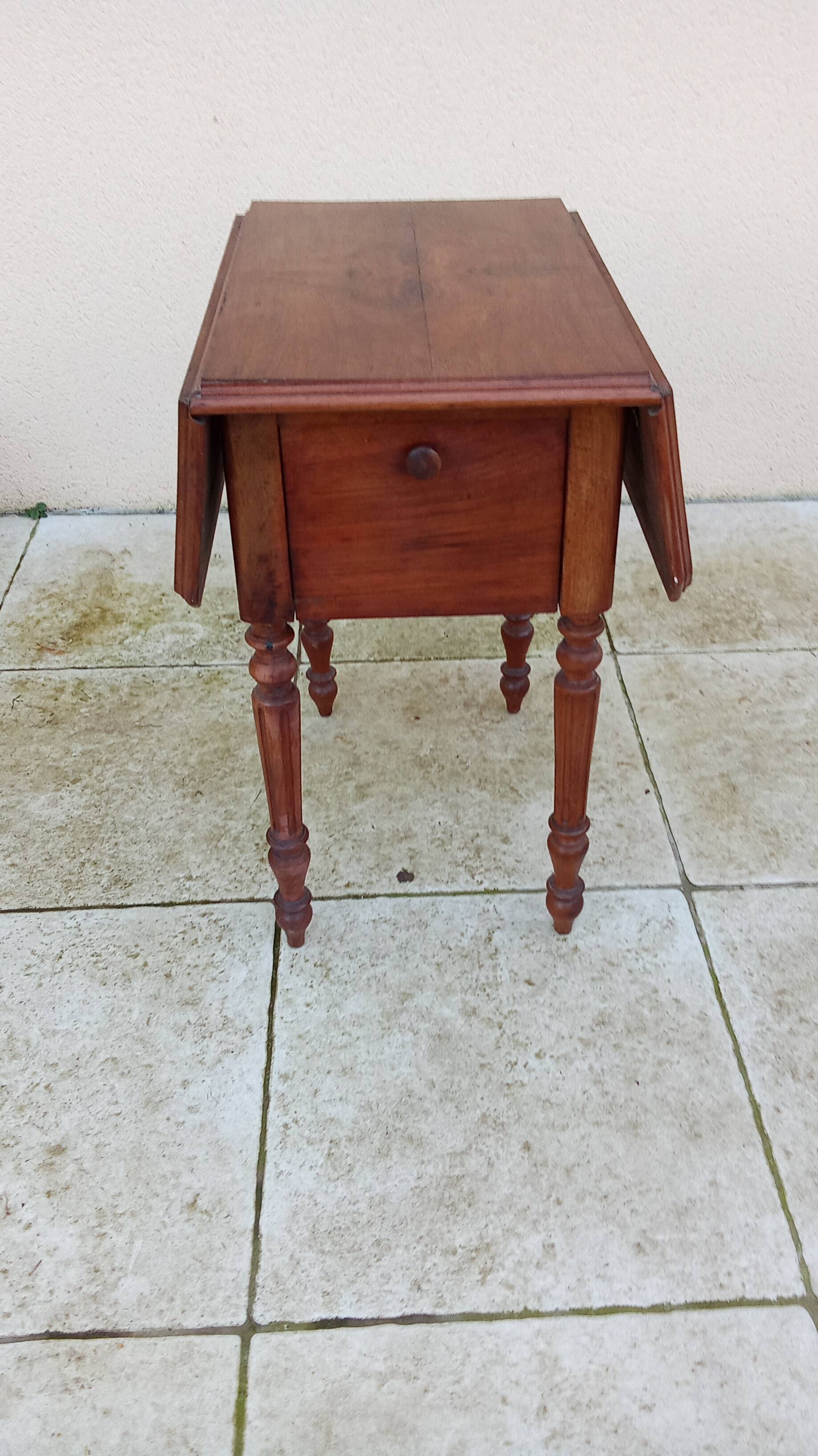 Antique small drop-leaf table from the 19th century.