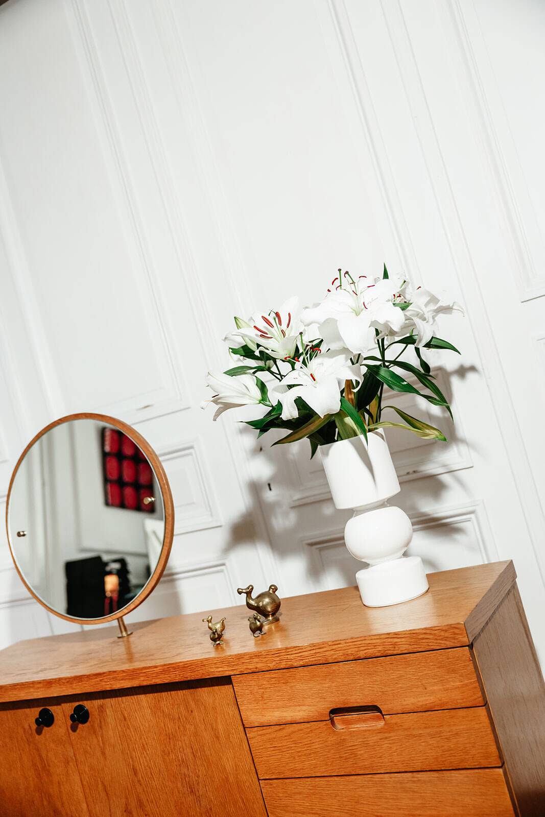 Vintage oak cabinet with circular mirror, 1960s modernist design.