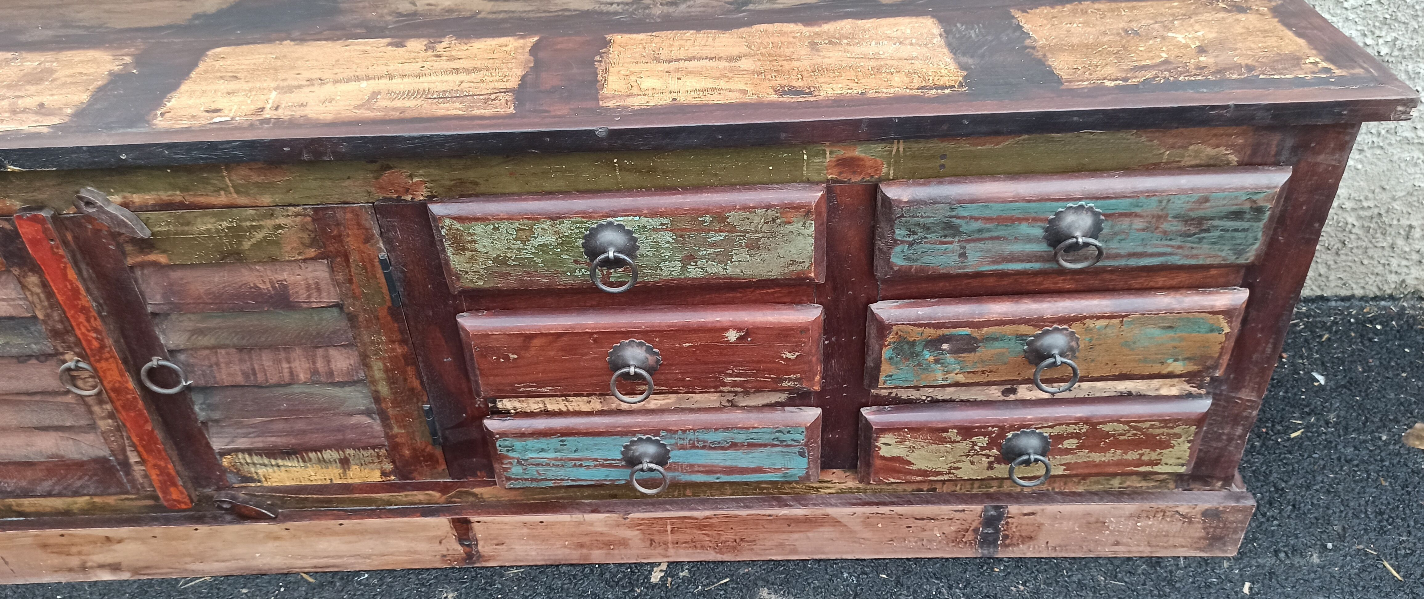 Furniture low in colorful wood. 12 drawers and 1 door