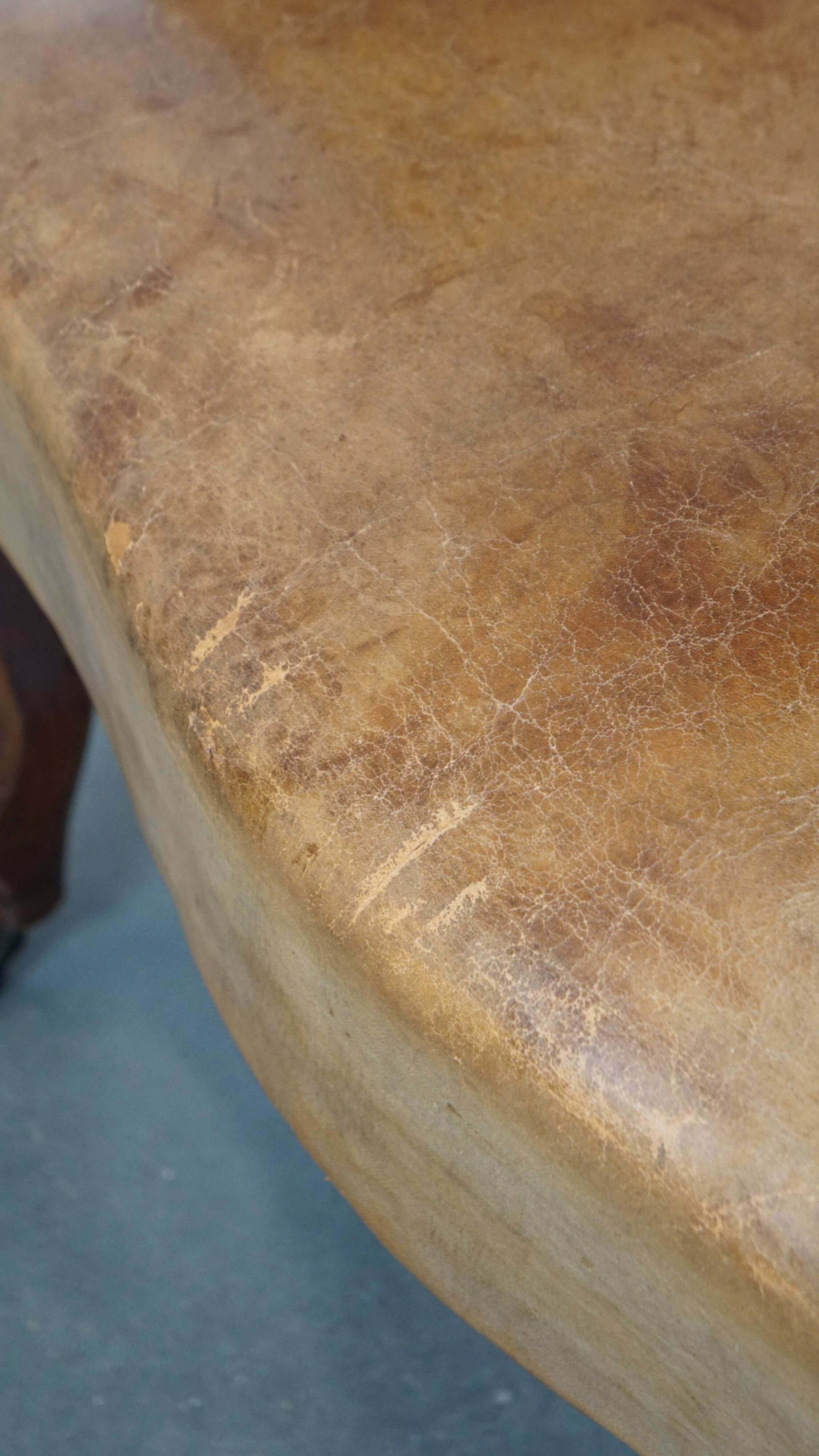 Antique sheep leather club chair/armchair on wheels