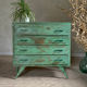 Vintage compass leg commode with a patina.