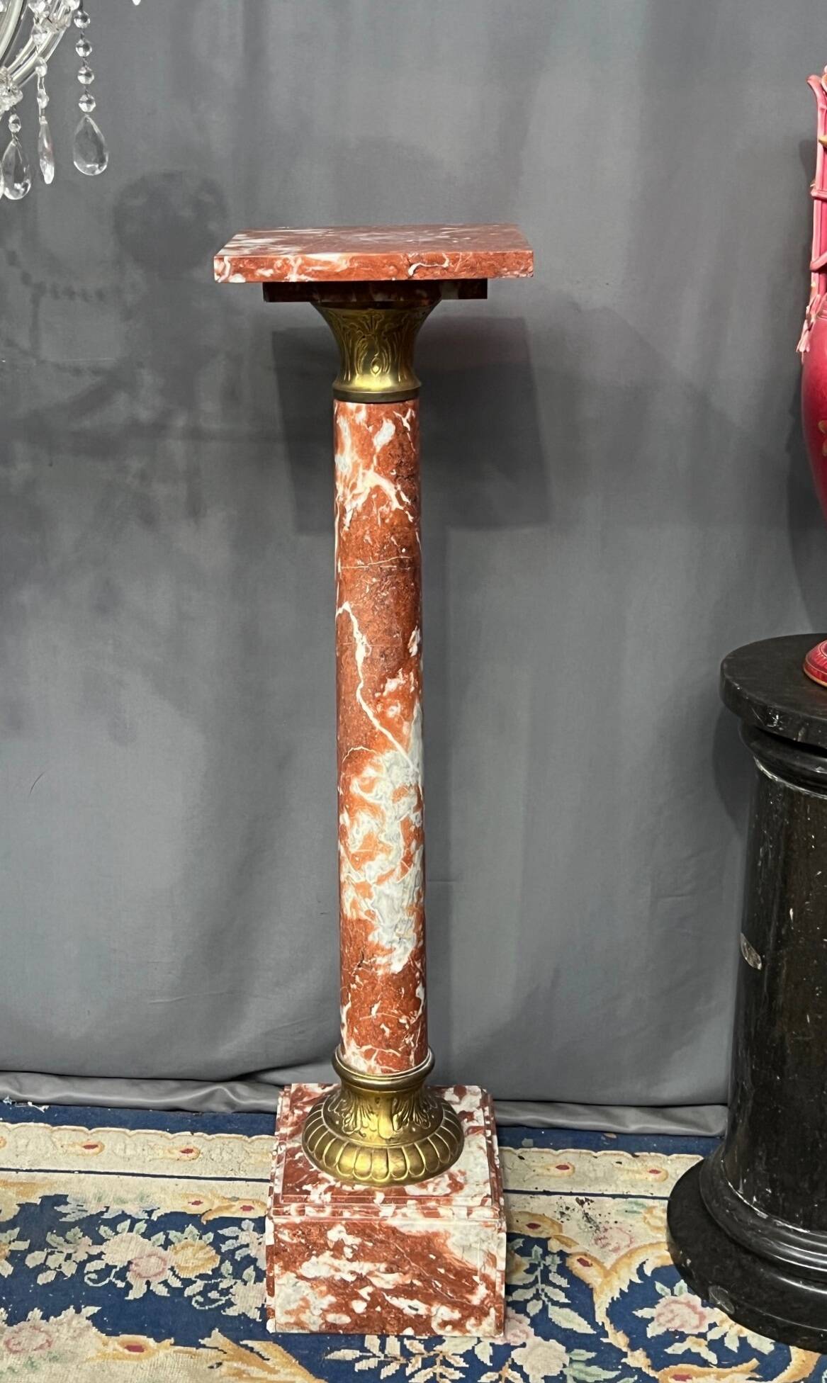 Marble pedestal decorated with gilded brass.