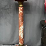 Marble pedestal decorated with gilded brass.