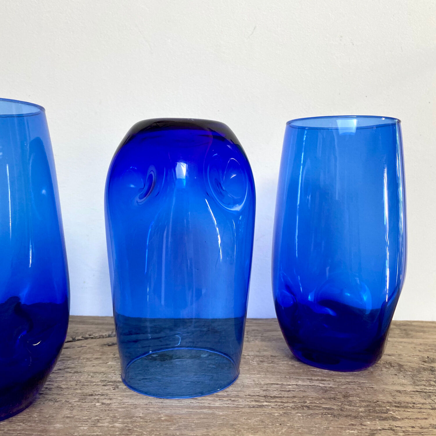3 blue colored long drink glasses