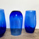 3 blue colored long drink glasses