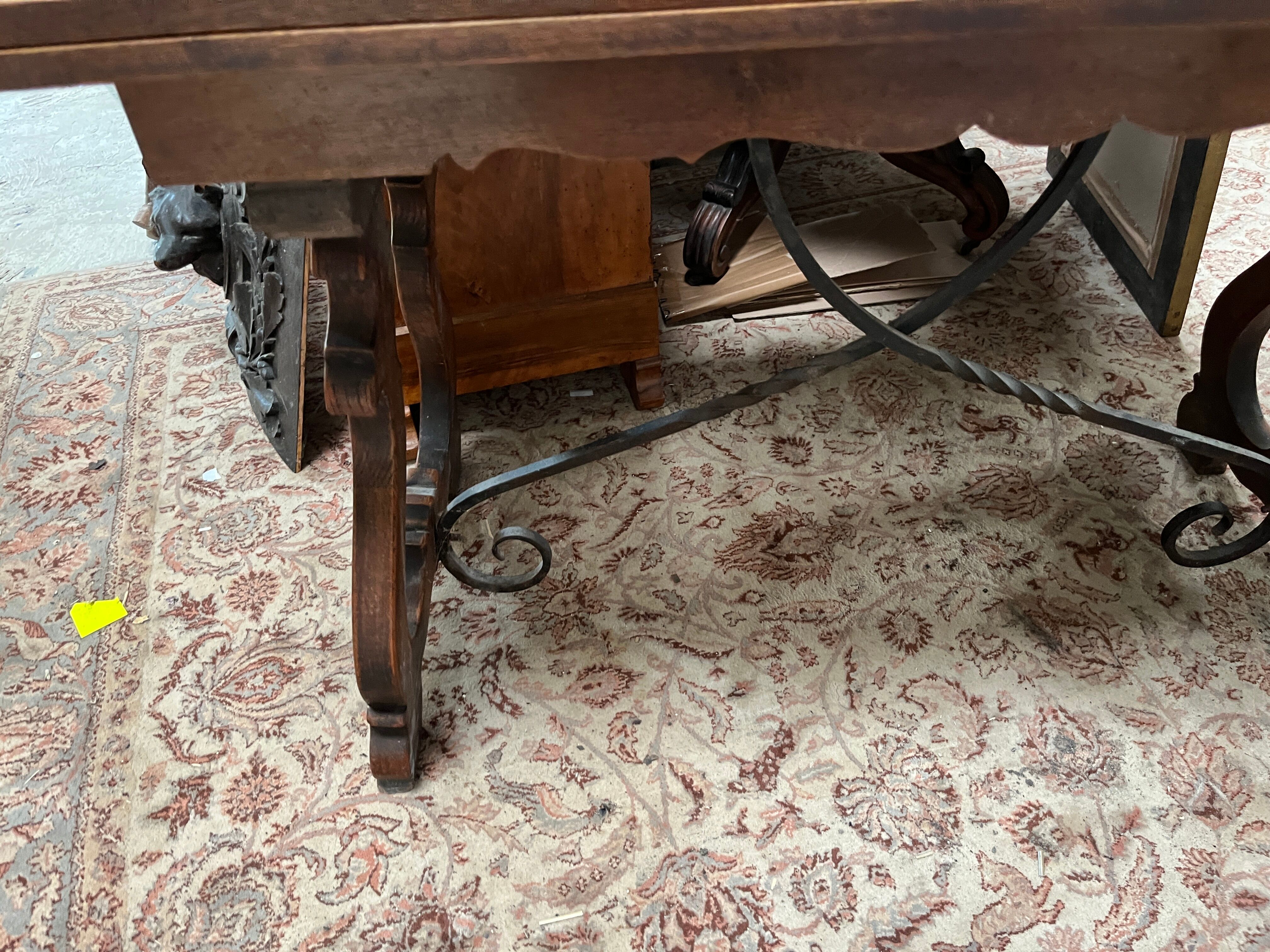 Spanish style table in carved wood and wrought iron
