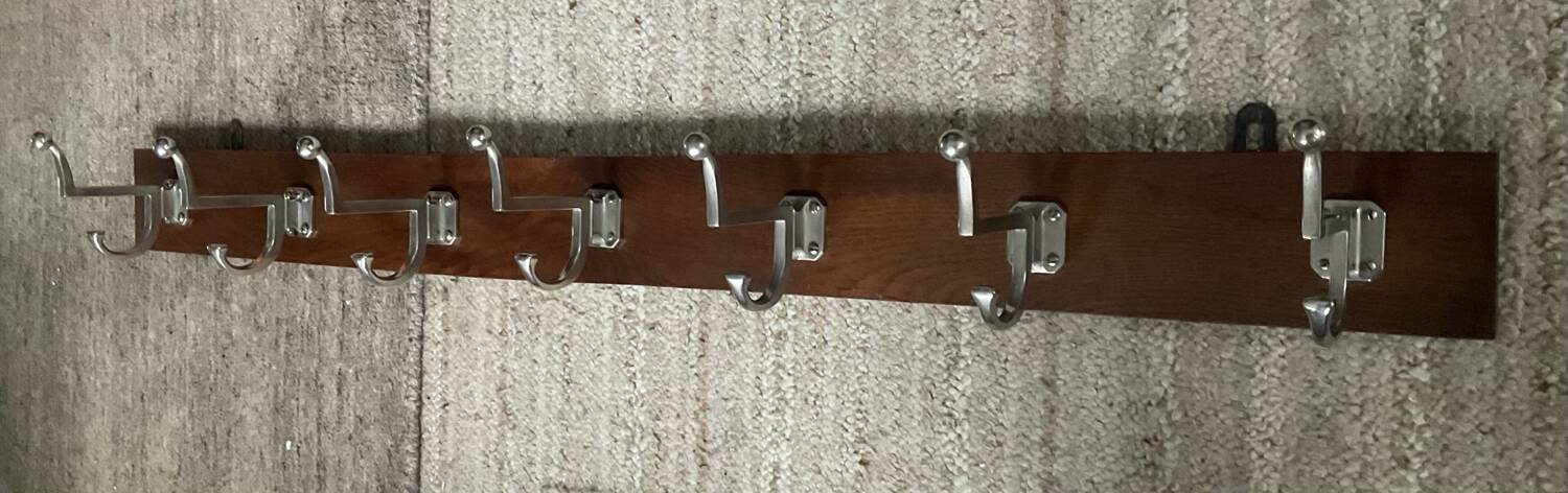 Wall coat rack from the 1950s-60s in solid oak and stainless steel.
