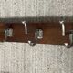 Wall coat rack from the 1950s-60s in solid oak and stainless steel.