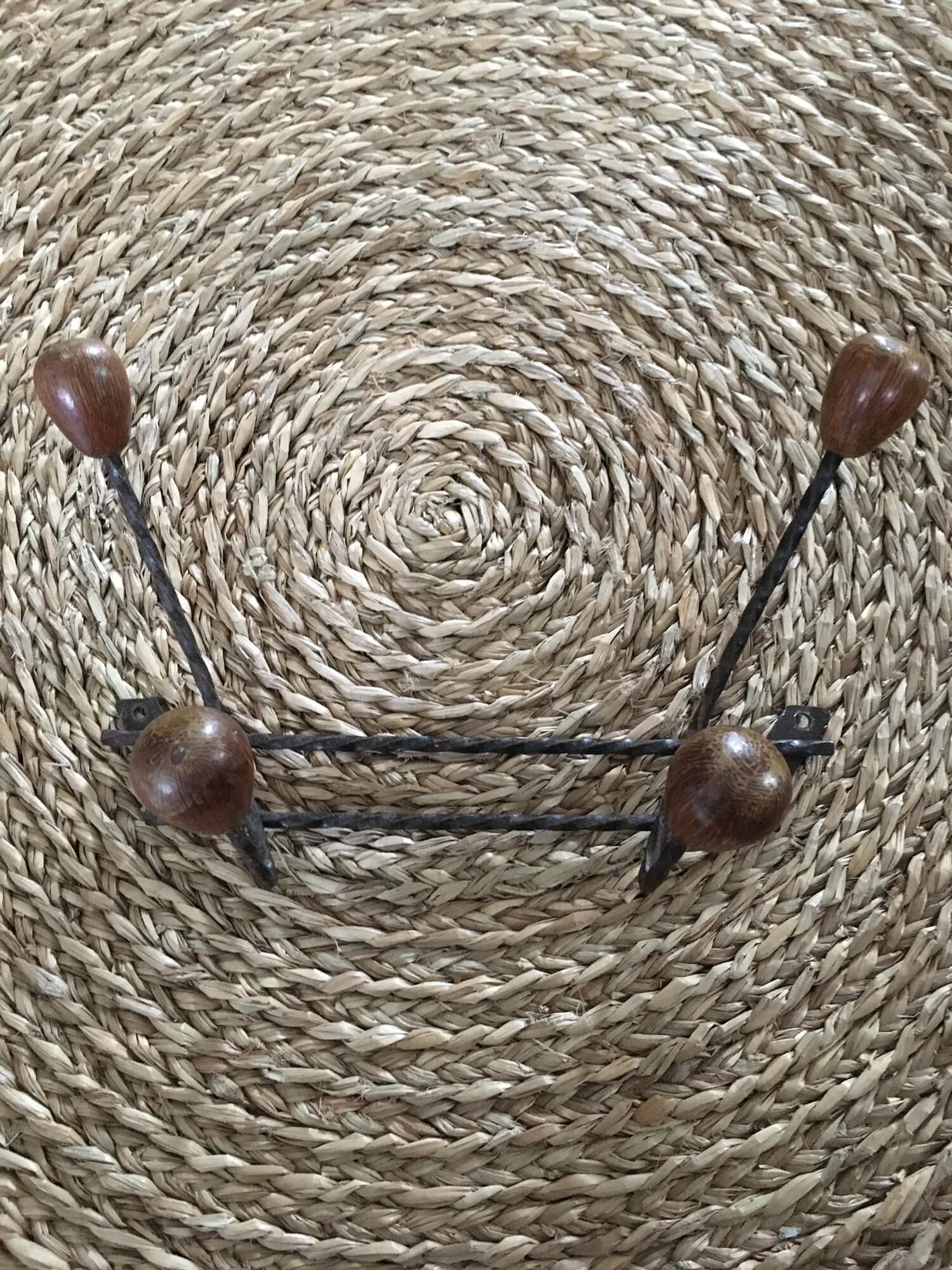 Old wrought iron coat rack. 4 hooks in chestnut wood