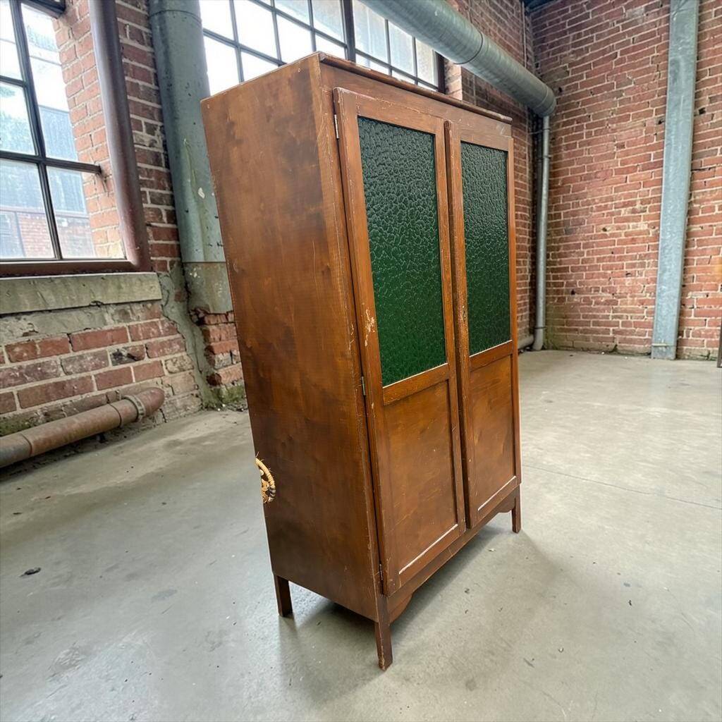 Vintage wooden display cabinet with green glass.