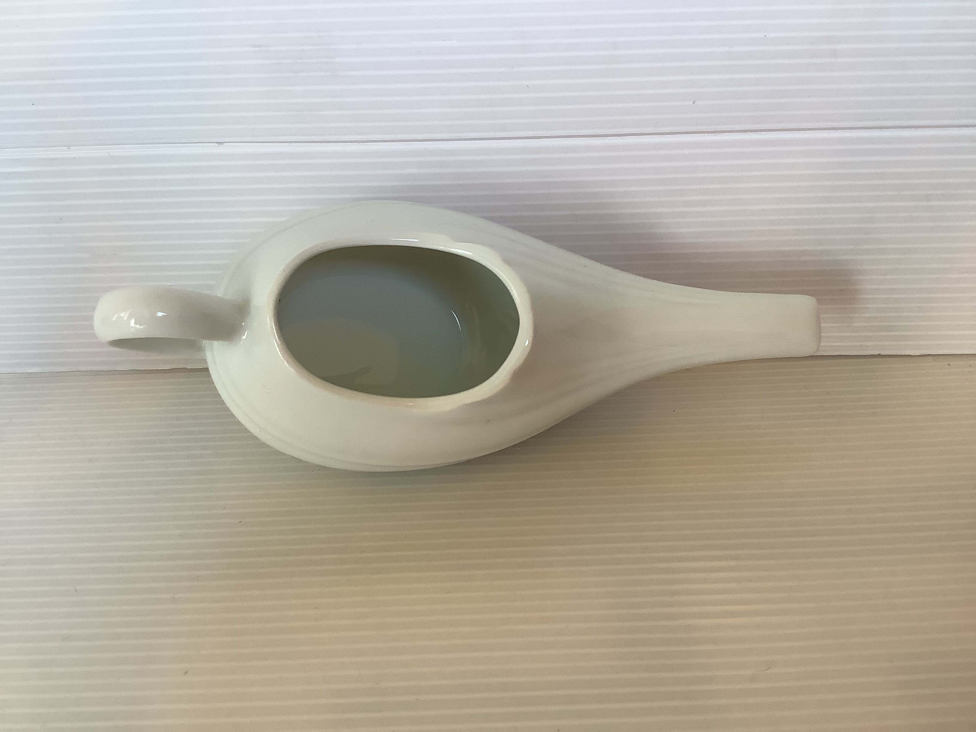 Old white porcelain baby bottle sauceboat
