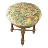 Old upholstered piano stool