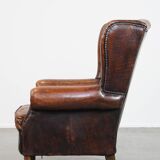 Cognac-colored vintage sheep leather wingback chair with character