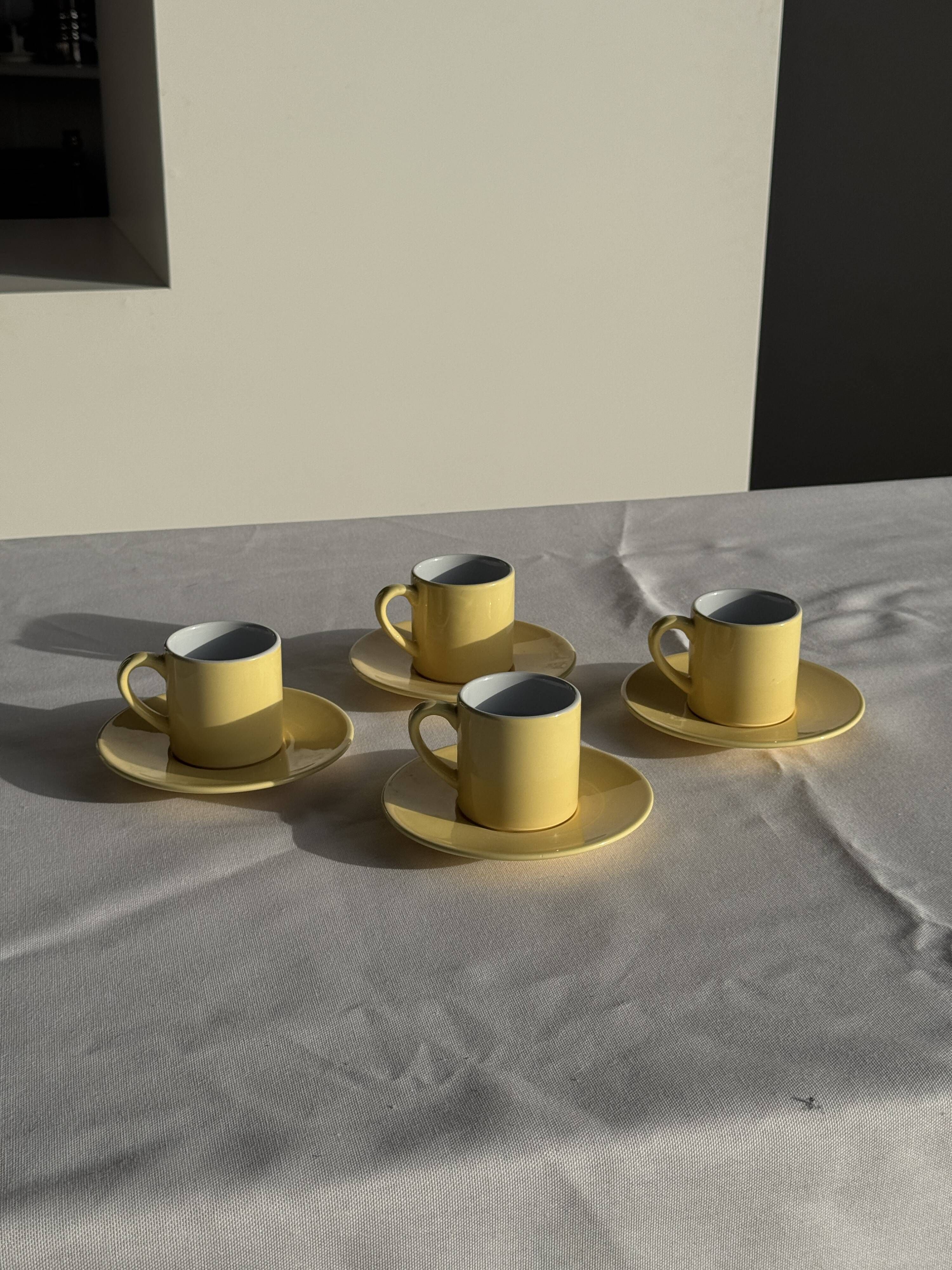 Set of 4 vintage yellow Italian espresso cups and saucers.