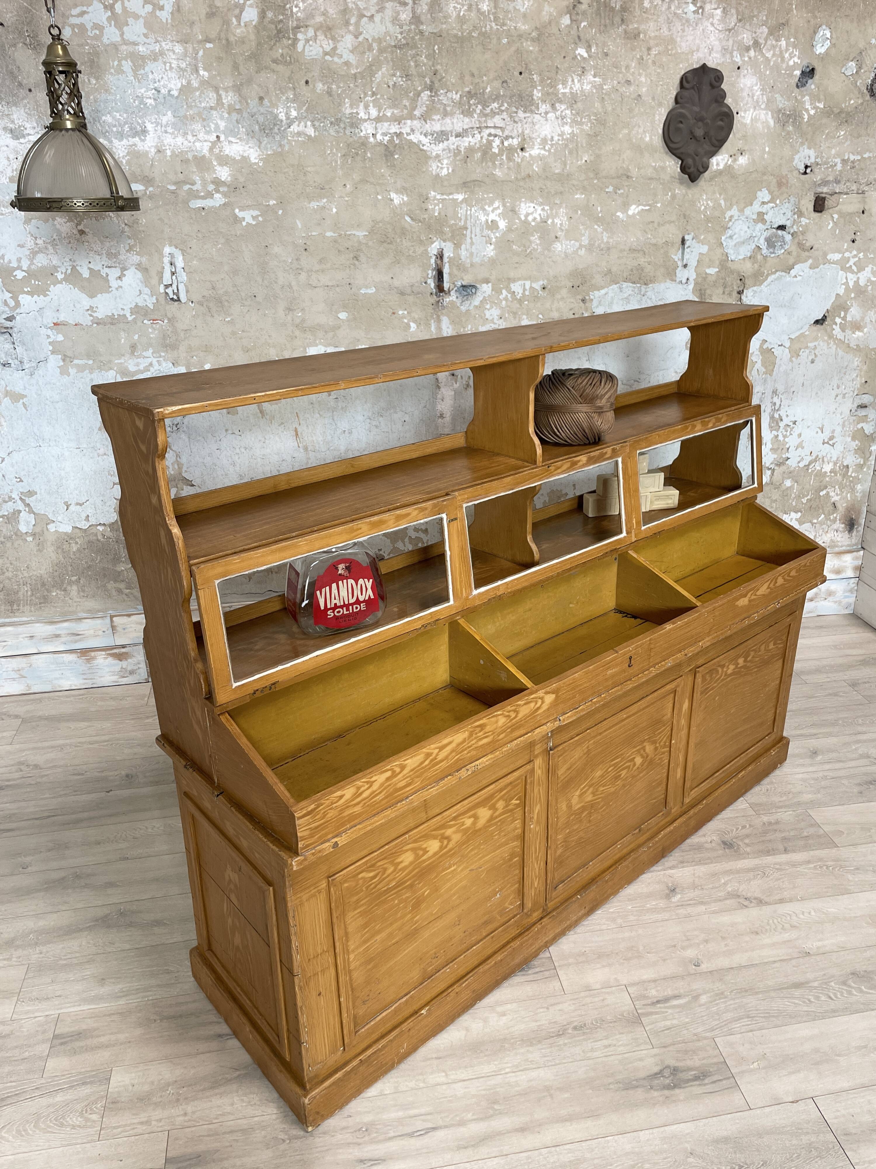 Wooden hardware cabinet painted with wood effect, circa 1940.