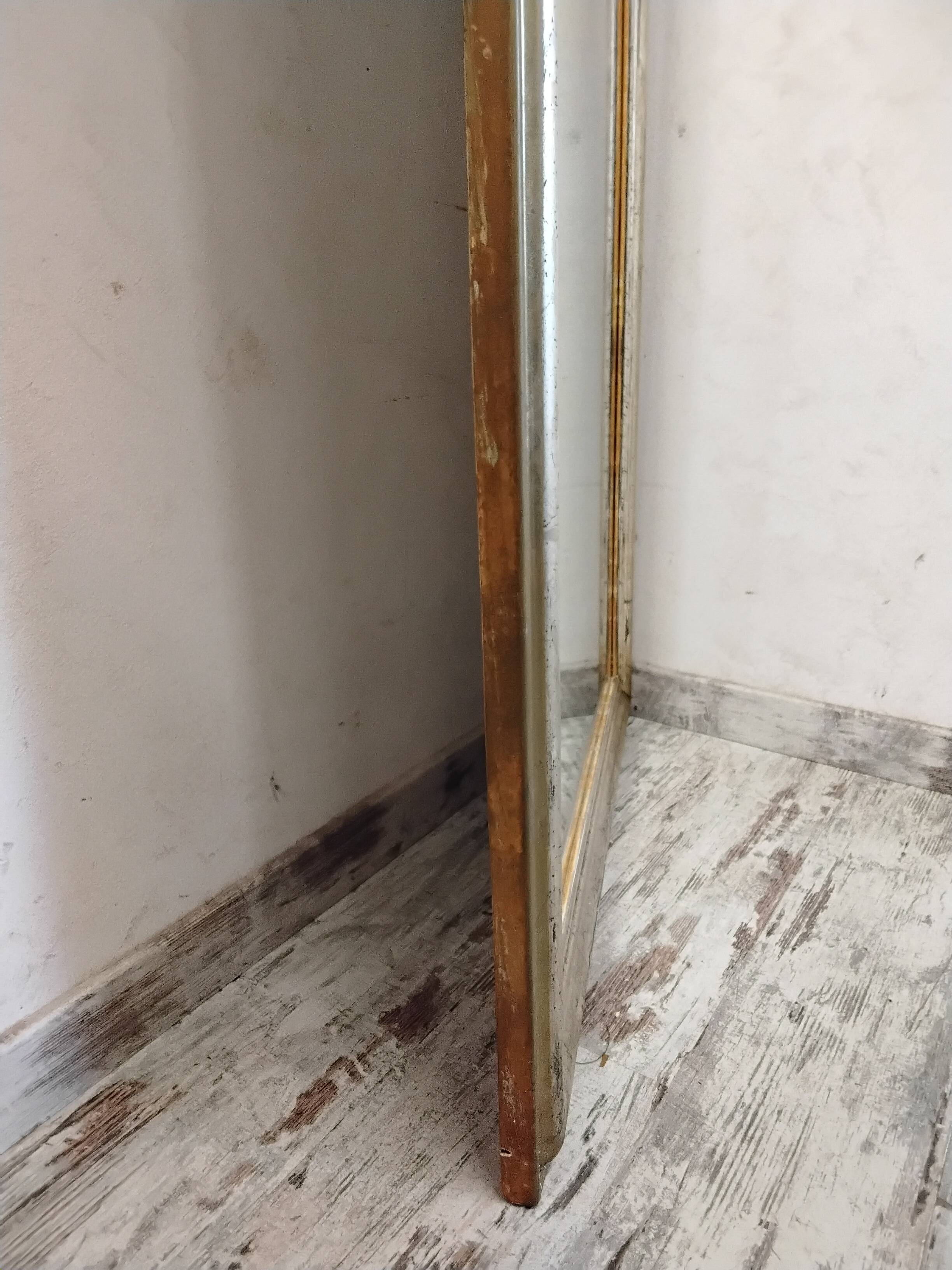 Antique mirror with a gilded frame and cherubs.