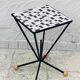 Wrought iron stela and black and white tiled top from the 1960s.