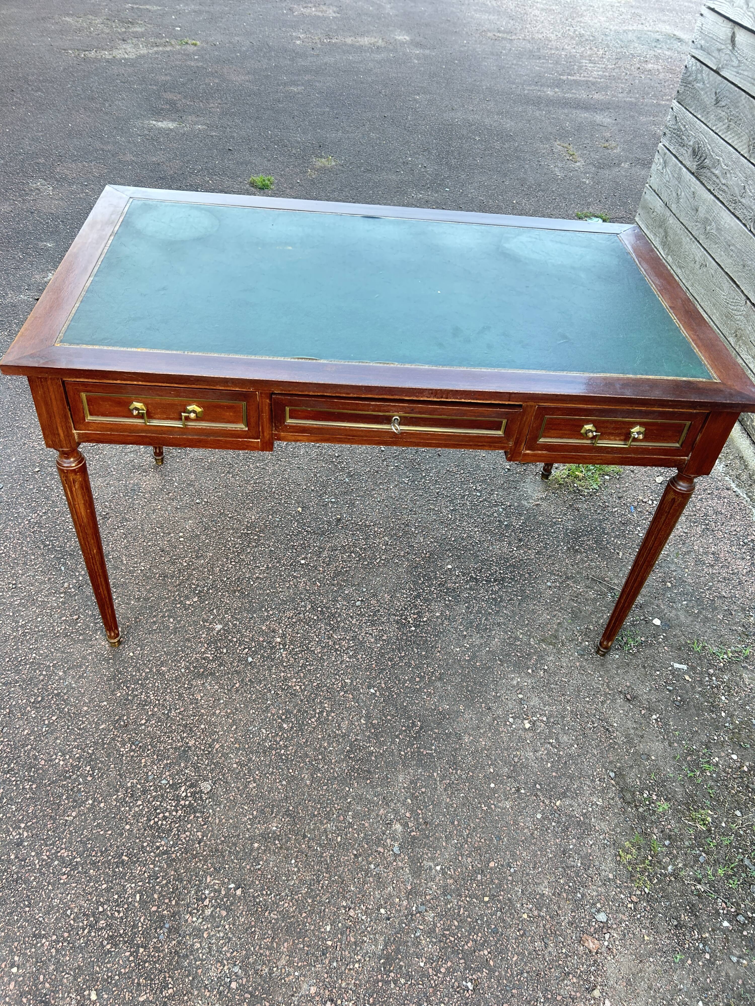 Louis XVI style desk in mahogany with a green leather top.