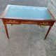 Louis XVI style desk in mahogany with a green leather top.
