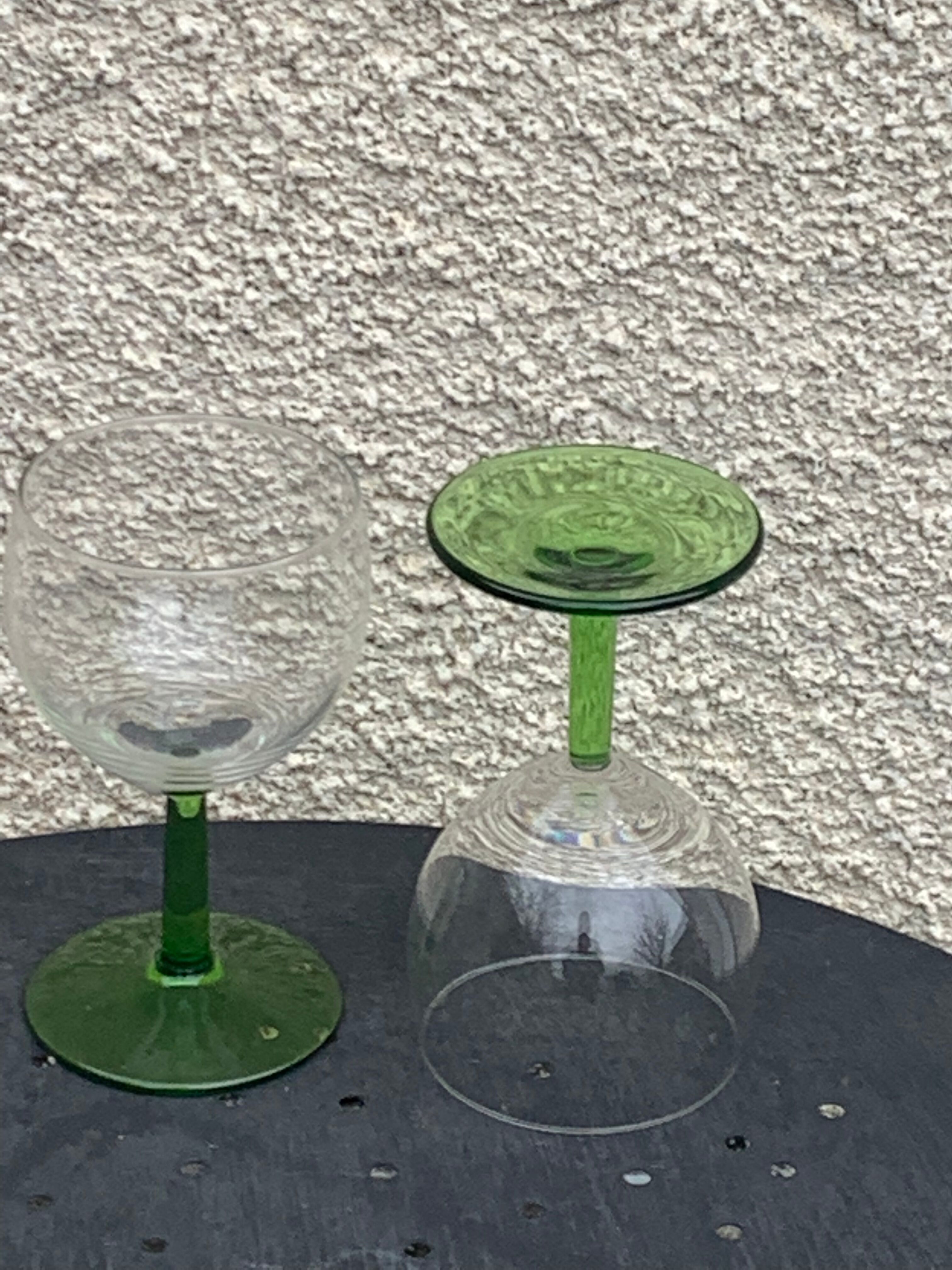 5 transparent glass glasses and green glass vase go