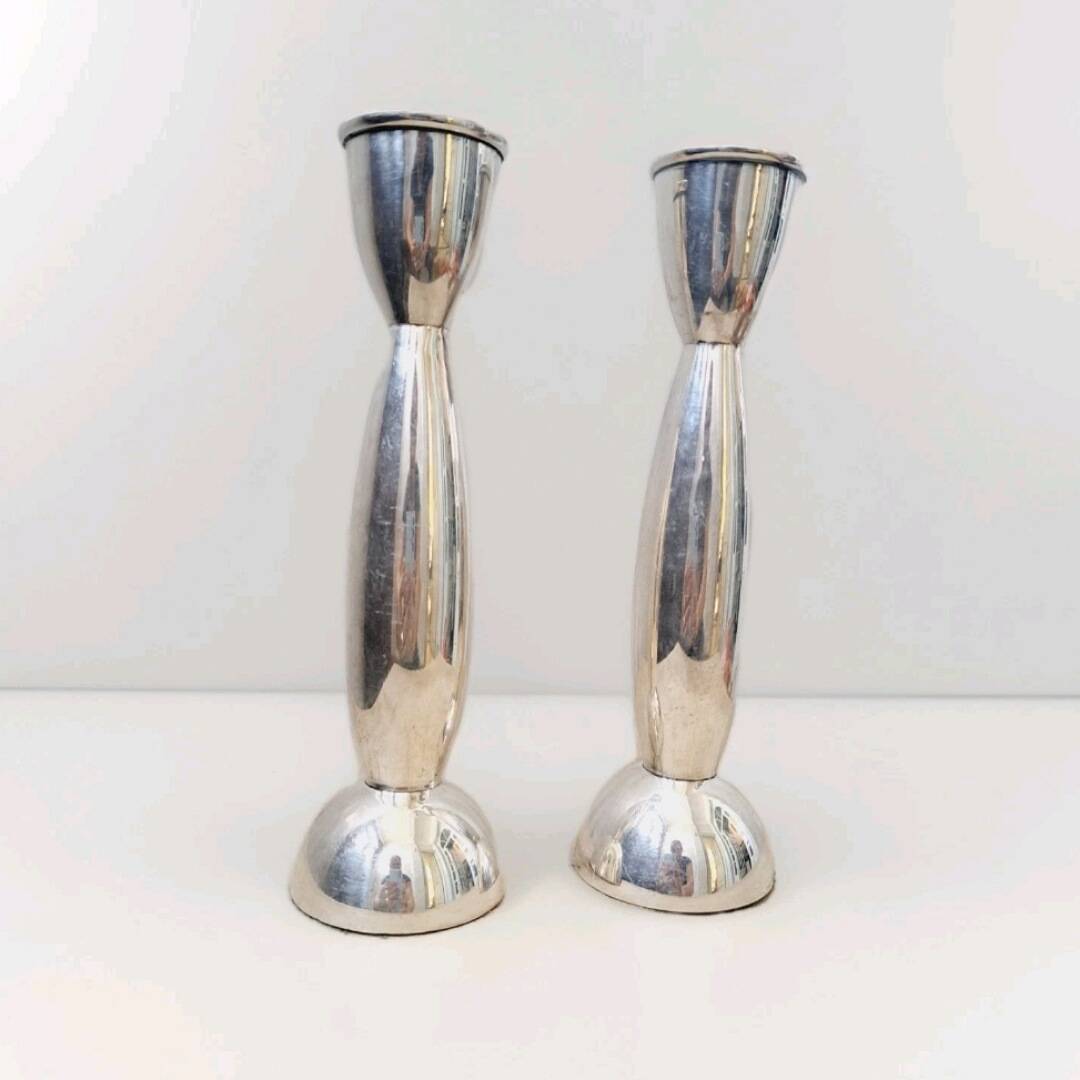 Pair of silver-colored metal candlesticks.