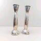Pair of silver-colored metal candlesticks.