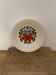Hungarian folk plate in white ceramic with hand-painted flowers, embossed edge.