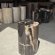 Black petrified wood side table with beige stripes and a semicircular shape.