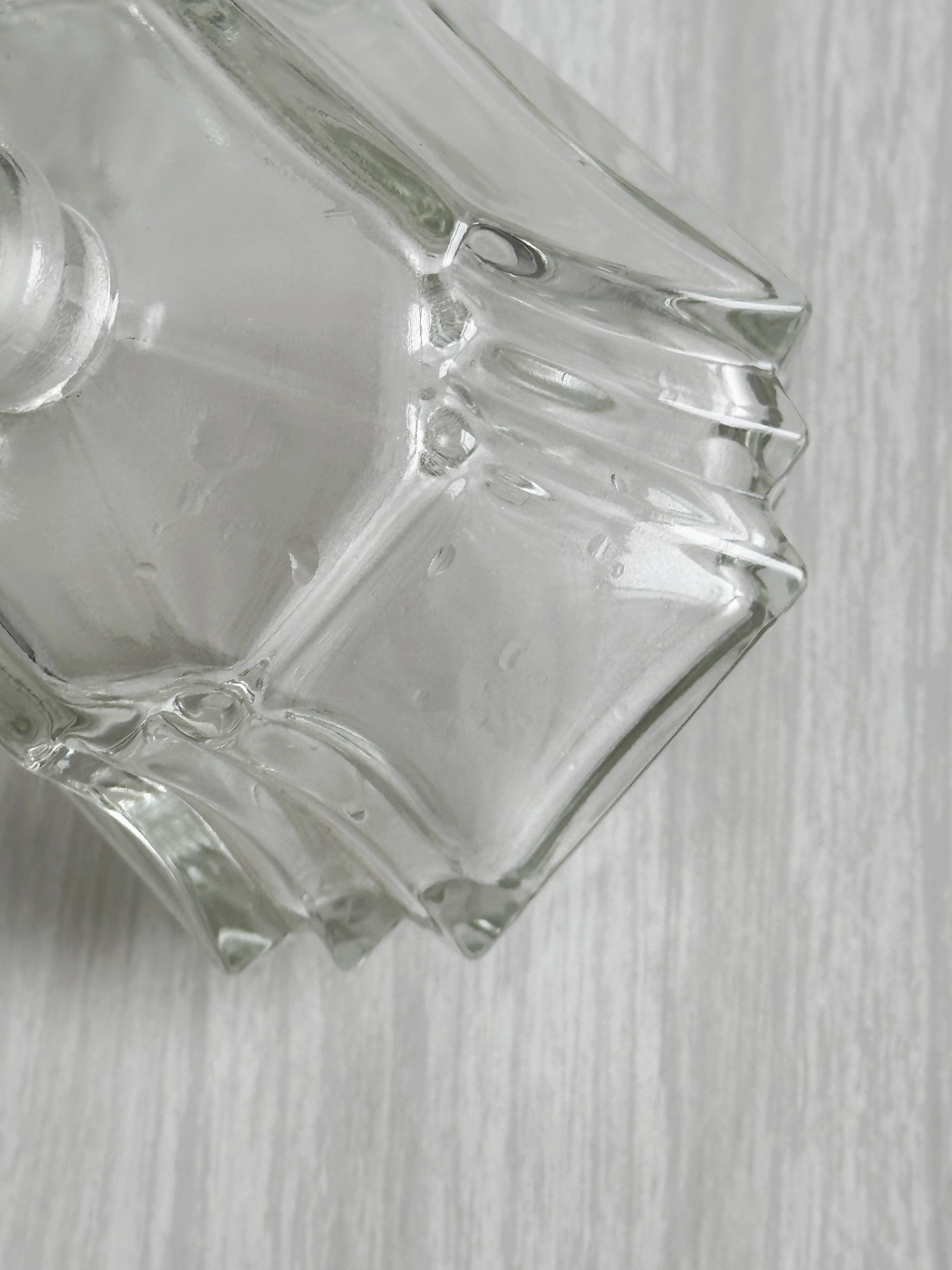 Small transparent faceted glass bottle