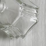 Small transparent faceted glass bottle