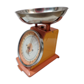 Orange metal household scale from 1970