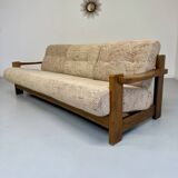 Old 3-seater sofa in solid wood, Maison Regain design, from the 70s.
