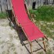 Former pliante long chair - wood foot rest - vintage red fabric