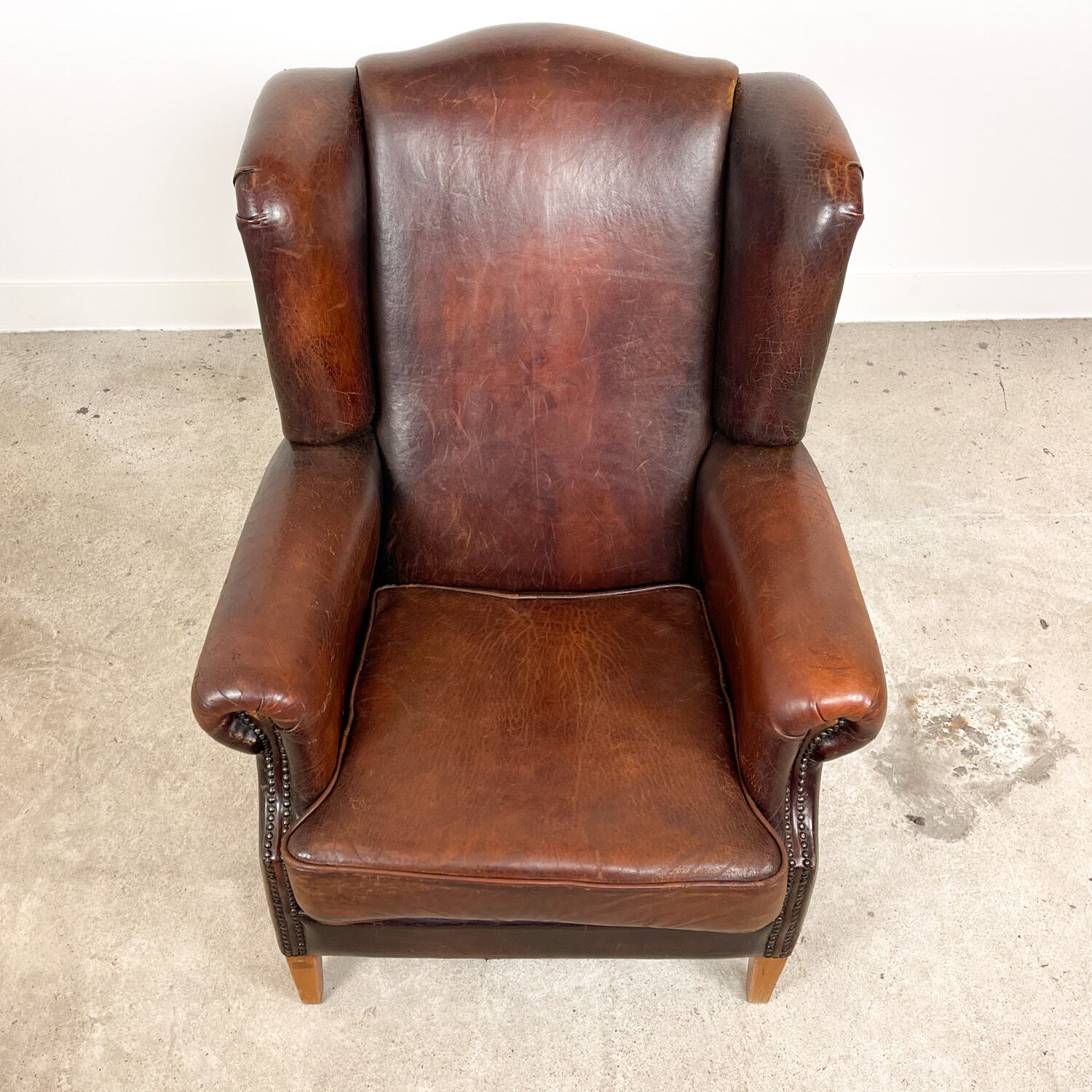 Dark brown vintage sheep leather wingback armchair
