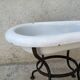 Antique bidet in enamelled sheet metal with wrought iron support