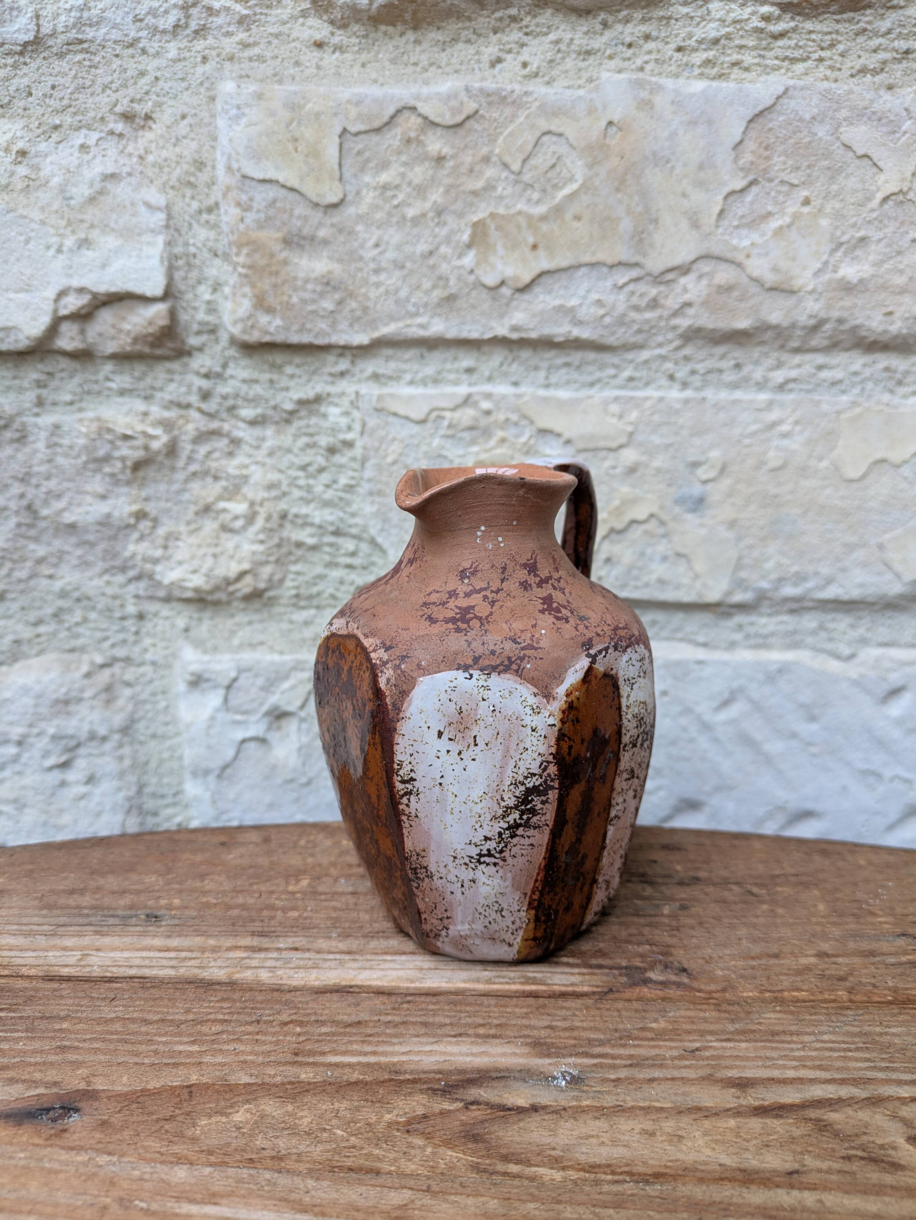 Old small pitcher in glazed terracotta