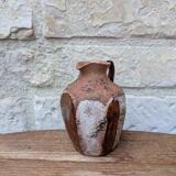 Old small pitcher in glazed terracotta